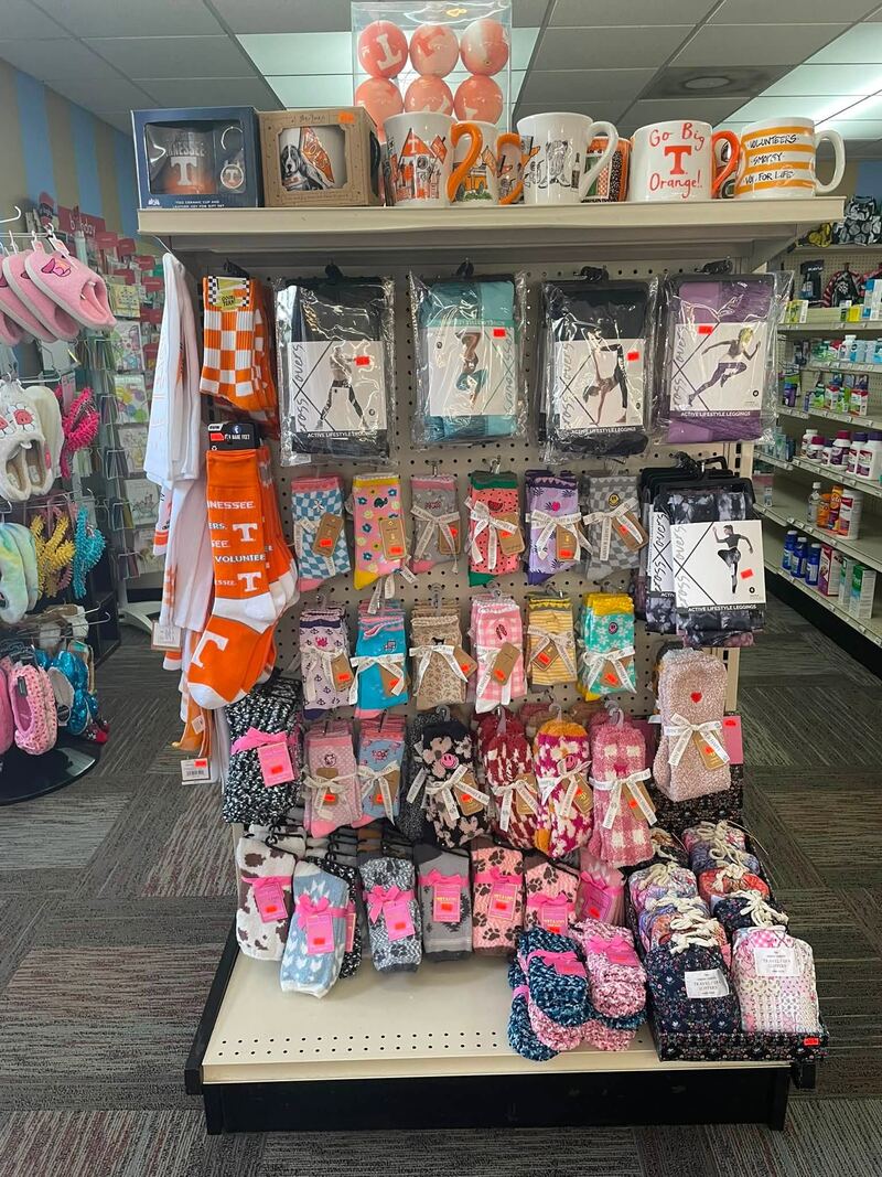 Gift shop end cap with mugs, socks, and hair accessories
