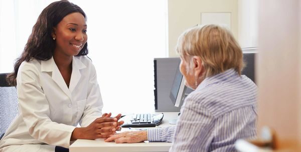 Pharmacist going over medications with an older adult