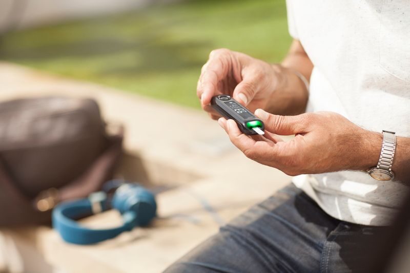 Person checking their blood sugar with a glucose meter